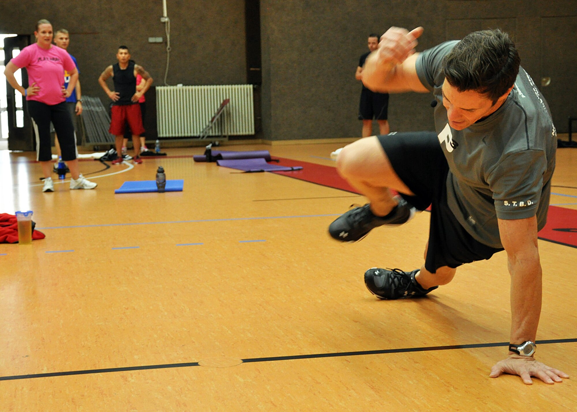 SPANGDAHLEM AIR BASE, Germany – Tony Horton, creator of the P90X workout program, demonstrates a technique during a workout session at the Skelton Memorial Fitness Center here Oct. 8. Horton visited Europe as part of an Armed Forces Entertainment tour to Italy, The Netherlands, Germany, Kosovo and the United Kingdom. Horton and his staff spoke with Airmen after the workout session about the relationship among exercise, diet, fitness and health. During the Europe trip, Horton taught two workouts here out of 13 at the seven visited military installations. More than 150 Saber Airmen participated.  (U.S. Air Force photo/Staff Sgt. Daryl Knee)