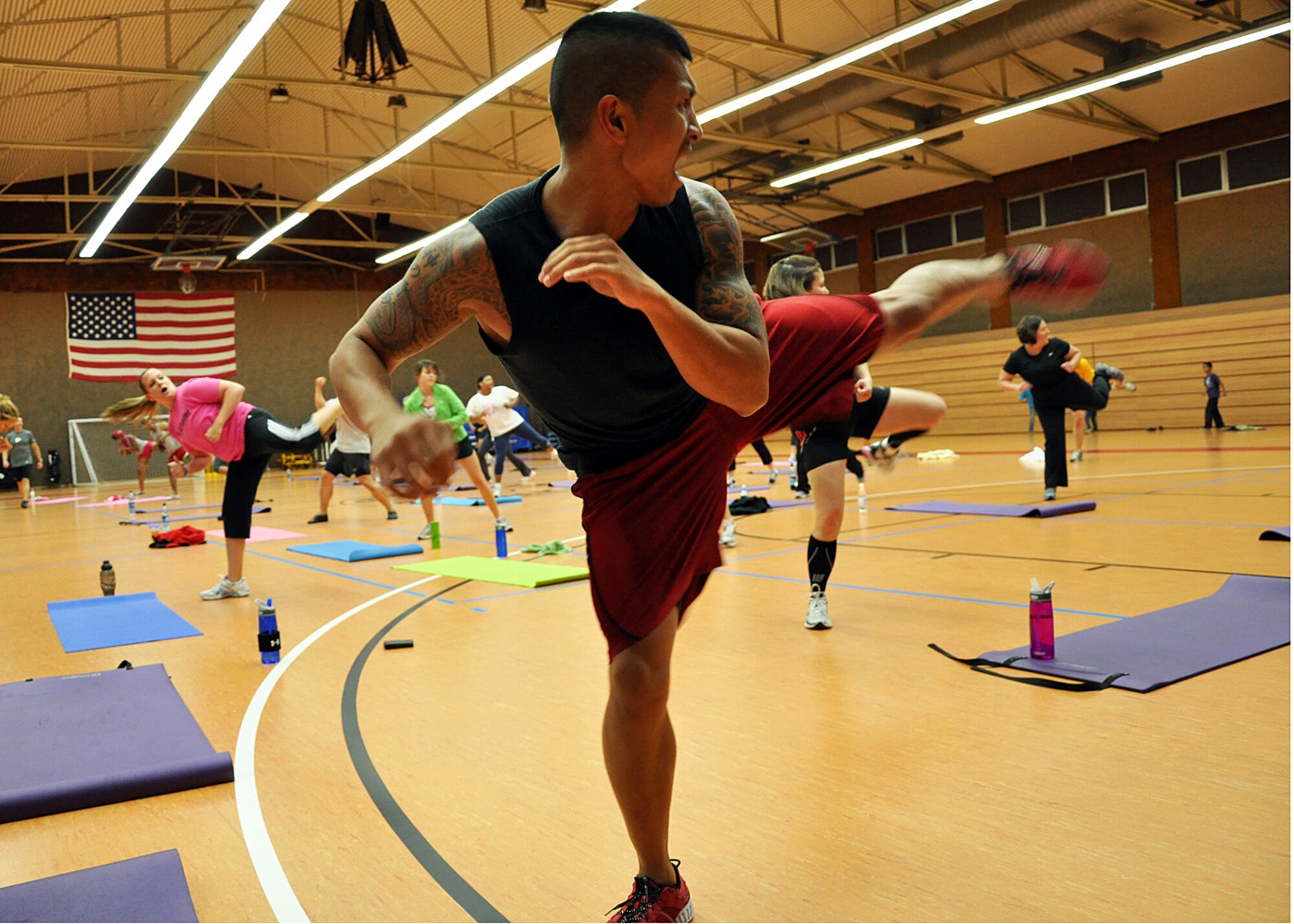 SPANGDAHLEM AIR BASE, Germany – Staff Sgt. Noel Abad, 86th Force Support Squadron, Ramstein Air Base, participates in the Kenpo X portion of a P90X workout session at the Skelton Memorial Fitness Center here Oct. 8. Tony Horton, creator of the program, visited Europe as part of an Armed Forces Entertainment tour to Italy, The Netherlands, Germany, Kosovo and the United Kingdom. Horton and his staff spoke with Airmen after the workout session about the relationship among exercise, diet, fitness and health. During the Europe trip, Horton taught two workouts here out of 13 at the seven visited military installations. More than 150 Saber Airmen participated. (U.S. Air Force photo/Staff Sgt. Daryl Knee)