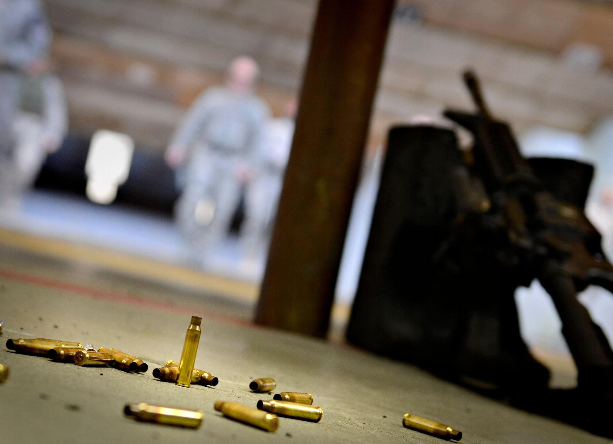 VOGELWEH, Germany – Empty cartridges sit on the ground of the firing range as shooters check their targets while taking the new Air Force rifle qualification course Oct. 7. The new course of fire has a mandatory implementation date of Dec. 1, 2011. (U.S. Air Force photo/Staff Sgt. Benjamin Wilson)