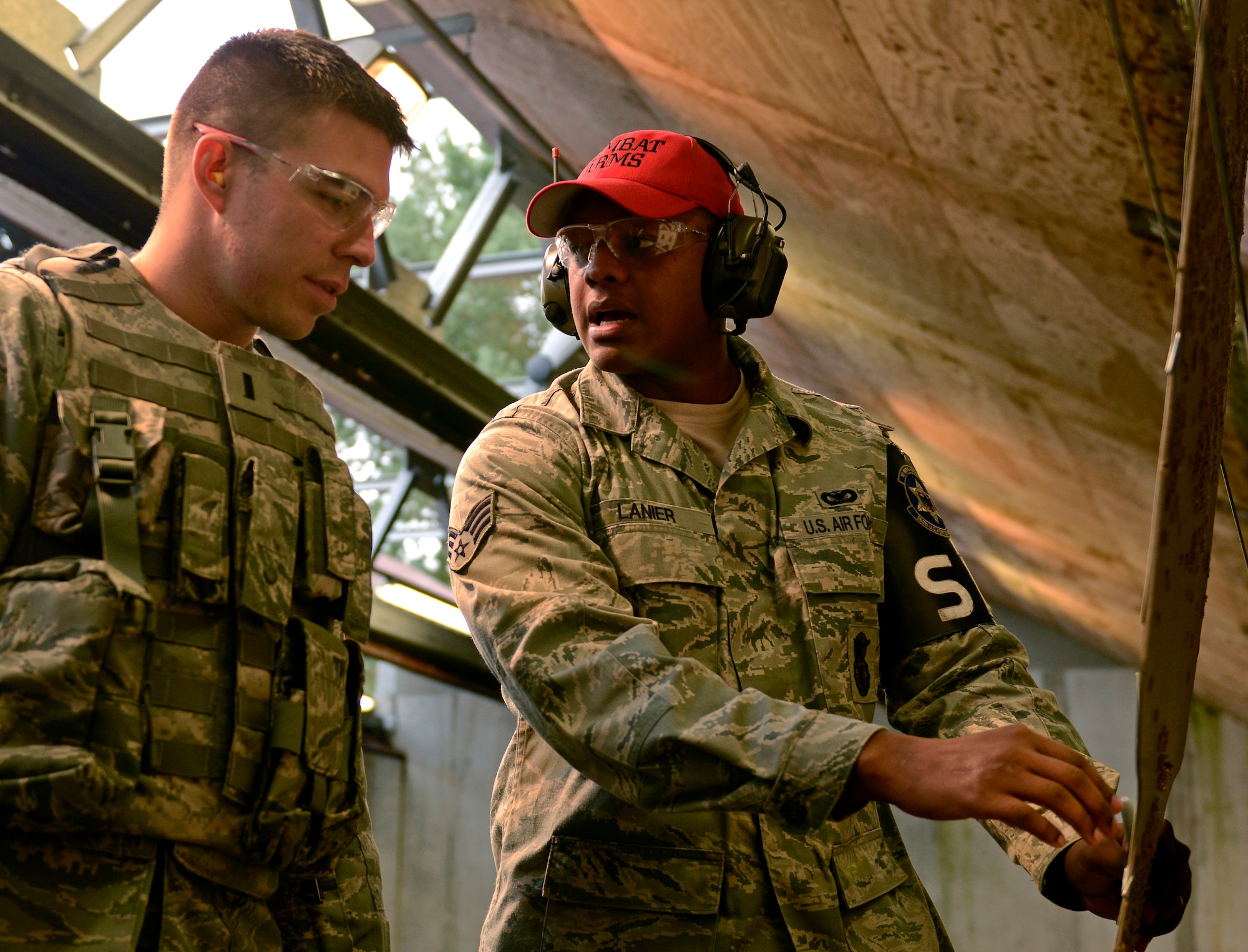 VOGELWEH, Germany – Senior Airman Jan Lanier, 569th U.S. Force Protection Squadron, helps 1st Lt. Jared Dorland, 569th USFPS, zero in his shots Oct. 7 during the new Air Force rifle qualification course. The new course of fire has a mandatory implementation date of Dec. 1, 2011. (U.S. Air Force photo/Staff Sgt. Benjamin Wilson)