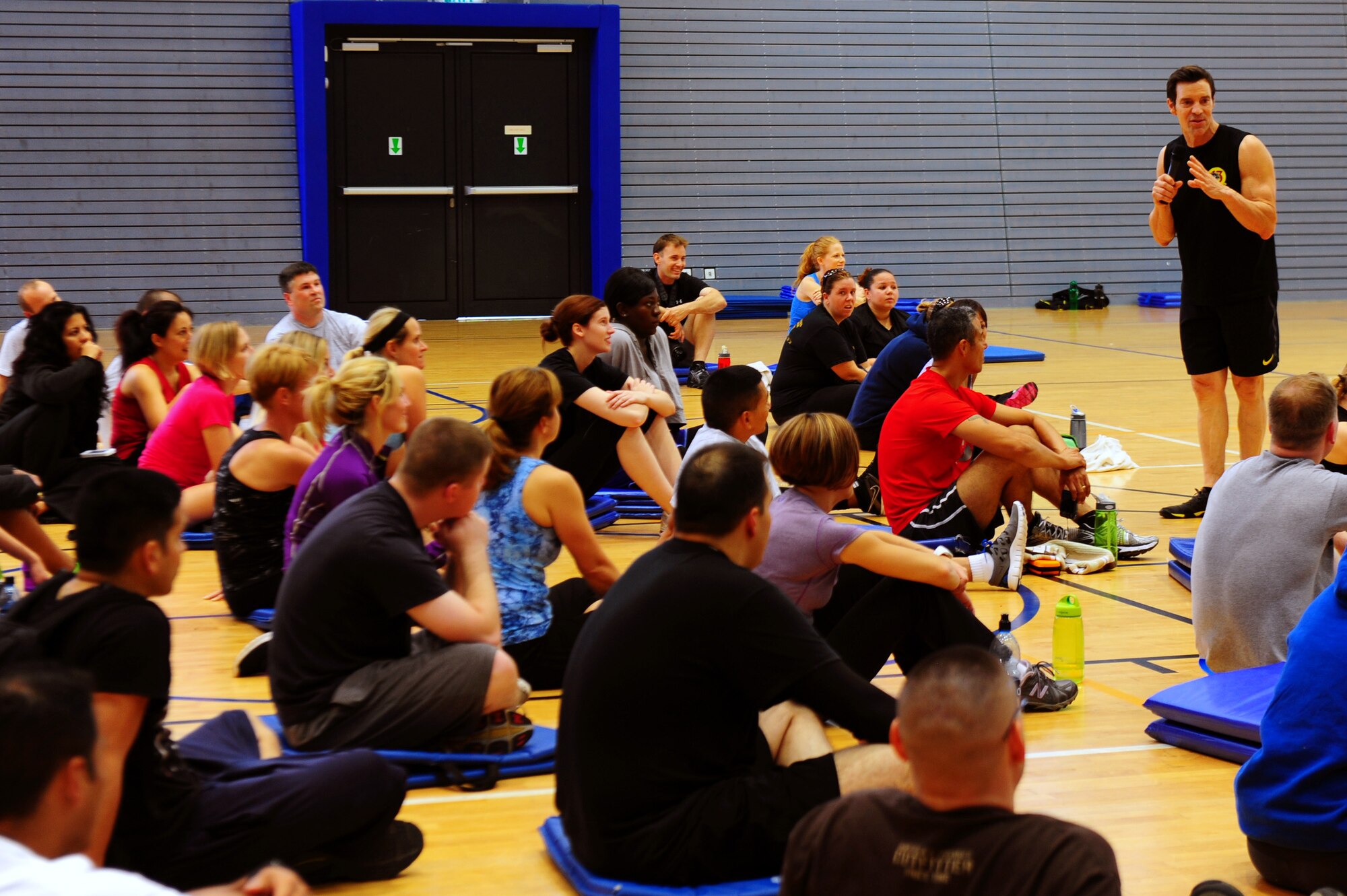 Tony Horton, creator of workout program P90X, talks health and wellness after a calisthenics routine at the southside gym, Ramstein Air Base, Germany, Oct. 7, 2011. Horton conducted two free strength training workout sessions for 325 military personnel and dependents. (U.S. Air Force photo by Airman 1st Class Brea Miller)