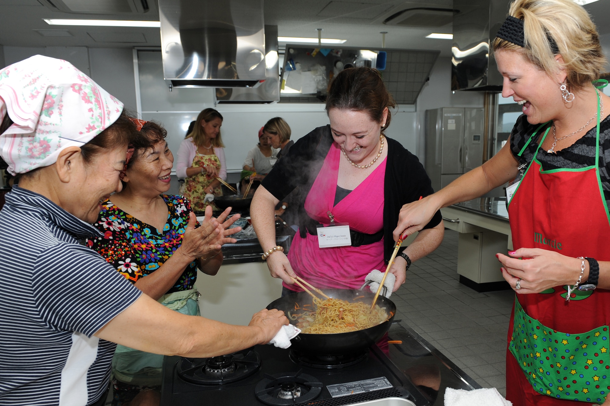 Tomiko Uezu,  Miyo Kinjo,  U.S. Air Force 2nd Lt. Hope Cronin and Marcie Chastain participate in a cultural exchange cooking class with members of the local community at the Kadena Town Rotary Plaza Oct. 5. The cooking class consisted of a briefing on how to cook particular Japanese dishes, cooking and tasting the dishes, and cleaning up. The American women are from Kadena Air Base and the Okinawan women are from the Kadena Chamber of Commerce Women’s Division. (U.S. Air Force photo/Junko Kinjo)