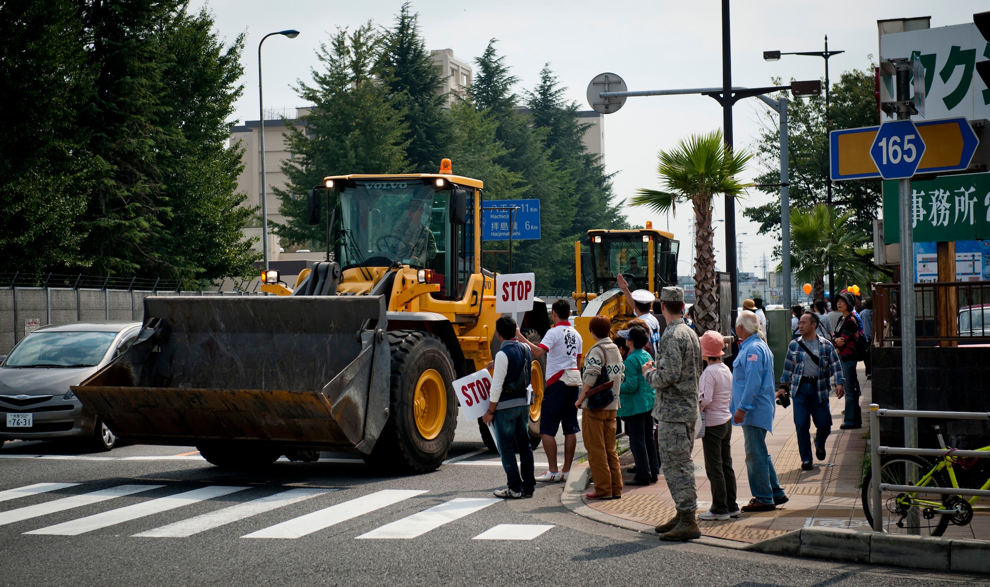 FUSSA CITY, Japan -- Front end loaders from the 374th Civil Engineer Squadron roll down Route 16 during the Fussa City International Fair, Oct. 9, 2011, in Fussa City, Japan. The fair was originally called the Fussa Import Fair, but was renamed the Fussa International Fair as the festival evolved from an event geared to promote business along the eastern edge of Fussa City to a celebration of community with the base and local populace. (U.S. Air Force photo/Staff Sgt. Samuel Morse)