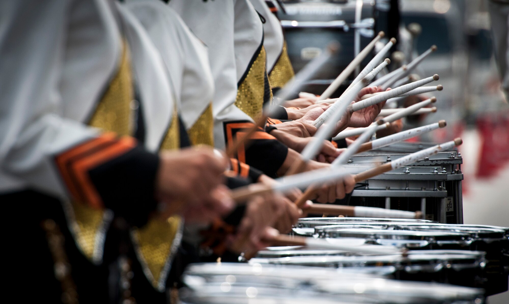 FUSSA CITY, Japan -- The Saitama Sakae Junior and Senior High School Marching Band drum line performs on Route 16 during the Fussa City International Fair, Oct. 9, 2011, in Fussa City, Japan. The band stopped during the parade to perform for the assembled crowd. (U.S. Air Force photo/Staff Sgt. Samuel Morse)