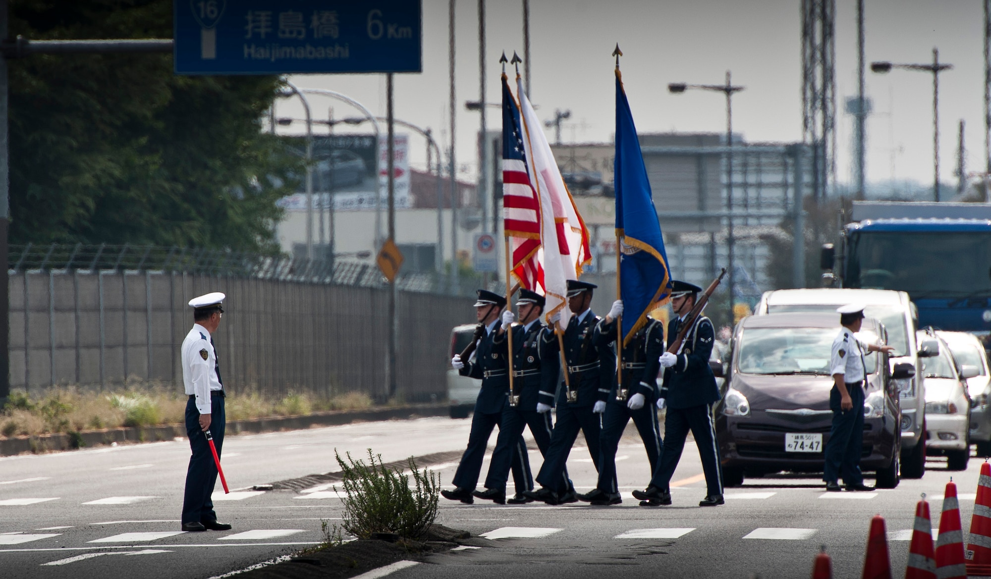 FUSSA CITY, Japan -- The Yokota Air Base Honor Guard marches down Route 16 during the Fussa City International Fair, Oct. 9, 2011, in Fussa City, Japan. Fussa City hosts the fair each year, celebrating shared culture and bringing the base and local community closer together. (U.S. Air Force photo/Staff Sgt. Samuel Morse)