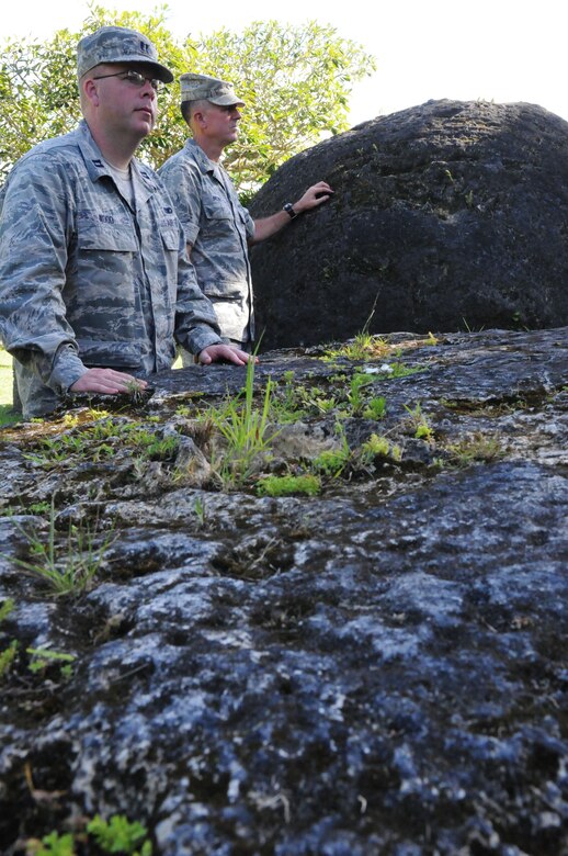 ANDERSEN AIR FORCE BASE, Guam –Capt. James Wood, 36th Wing Commander’s executive officer, and Col. Peter Brewer, 36th Medical Group commander, stand next latte stones during a staff visit and historical tour of  Tinian Island Oct. 11. The latte stones are one of twelve from the house of Taga, which are approximately 20-feet in length.(U.S. Air Force photo/ Senior Airman Carlin Leslie)