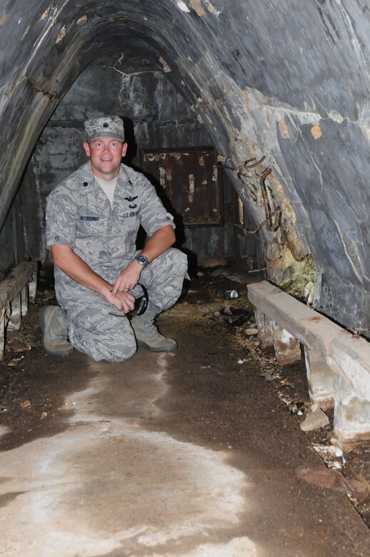 ANDERSEN AIR FORCE BASE, Guam – Lt. Col. Steven Bording, 36th Operations Support Squadron commander, kneels down inside an air raid shelter during a staff visit and tour of Tinian Island Oct. 11. The shelter is one of four that were located right outside the Japanese command post on the island. (U.S. Air Force photo/ Senior Airman Carlin Leslie)