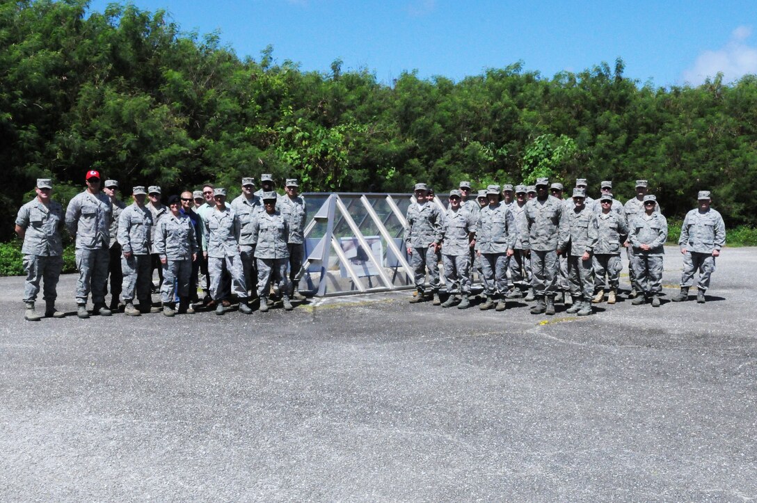 ANDERSEN AIR FORCE BASE, Guam – Senior leaders of Team Andersen pose for a photo next to a atomic bomb pit during a staff visit and tour of  Tinian Island, Oct. 11. The bomb pit was used during World War II, to allow servicemembers to load the two atomic bombs, “Little Boy” and “Fat Man,” during the war. (U.S. Air Force photo/ Senior Airman Carlin Leslie)