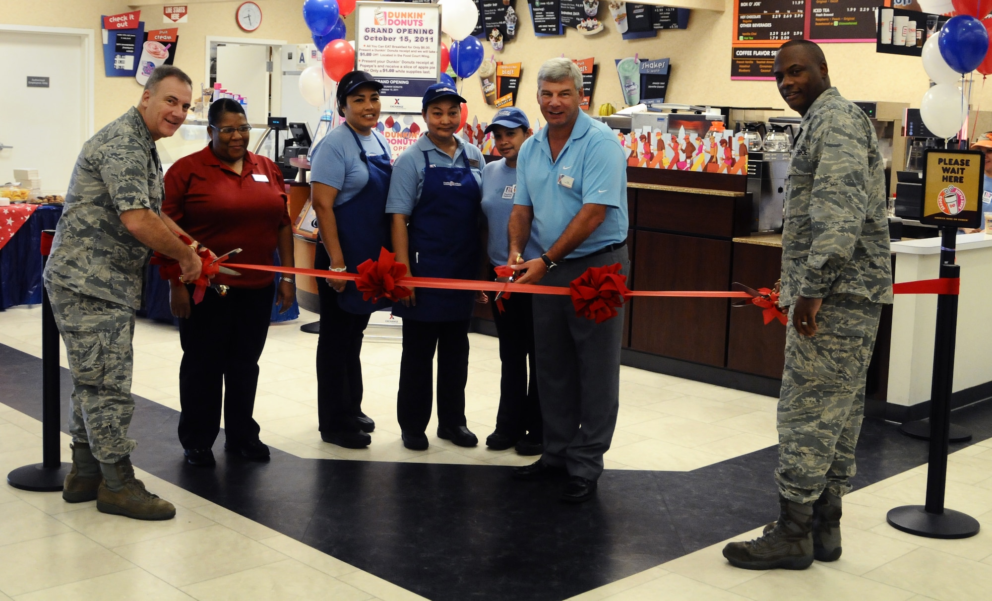 ANDERSEN AIR FORCE BASE, Guam—Leadership from Andersen cut the ceremonial ribbon with Exchange personnel during the grand opening of a Dunkin Donuts coffee shop here, Oct. 14. The Army and Air Force Exchange Service (AAFES) opted to put in a coffee shop after a receiving positive input from the base community. (U.S. Air Force photo by Senior Airman Benjamin Wiseman/Released)