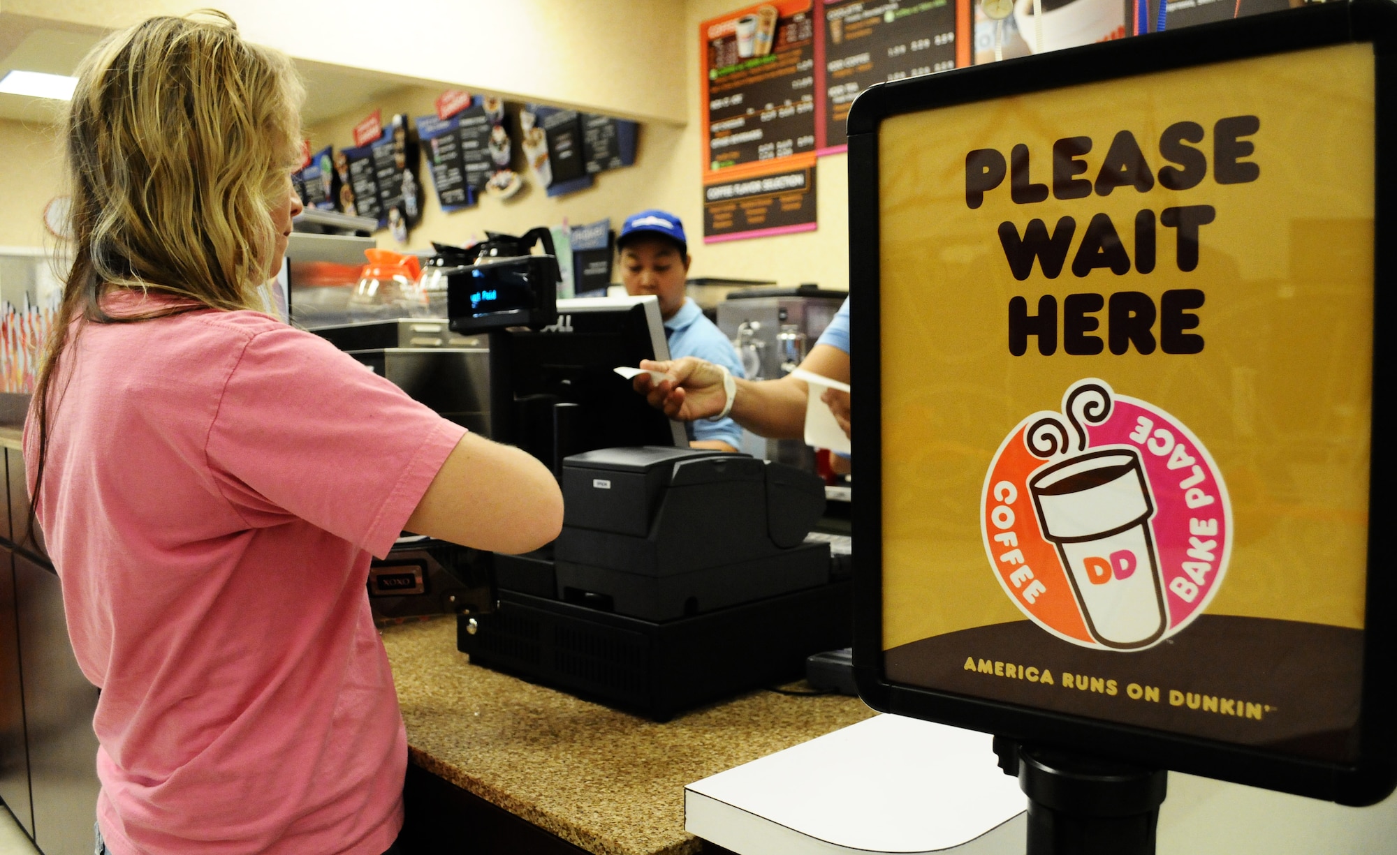 ANDERSEN AIR FORCE BASE, Guam—A member of the Andersen community purchases one of the first coffee drinks from the new Duncan Donuts at the Exchange here, Oct. 14. The addition of the new store gives personnel the option for a coffee shop that will remain open throughout the day. (U.S. Air Force photo by Senior Airman Benjamin Wiseman/Released)