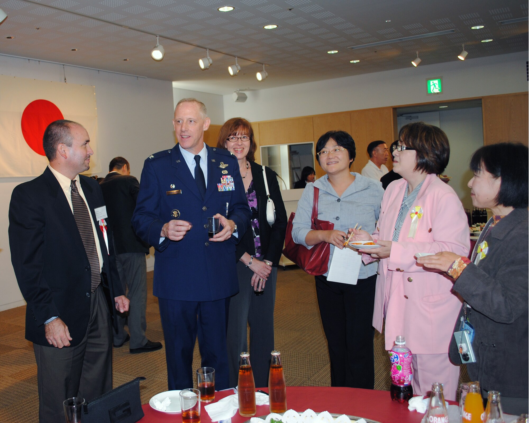 HAMURA, Japan -- Col. Otto Feather, 374th Airlift Wing commander, speaks with Base Exchange employees following the 2011 U.S. Forces, Japan Length of Service Awards Ceremony in Hamura City, Oct. 13, 2011. The ceremony honored 171 Japanese employees who have served with USFJ for 10, 20 and 30 years. (U.S. Air Force photo/Capt. Raymond Geoffroy)
