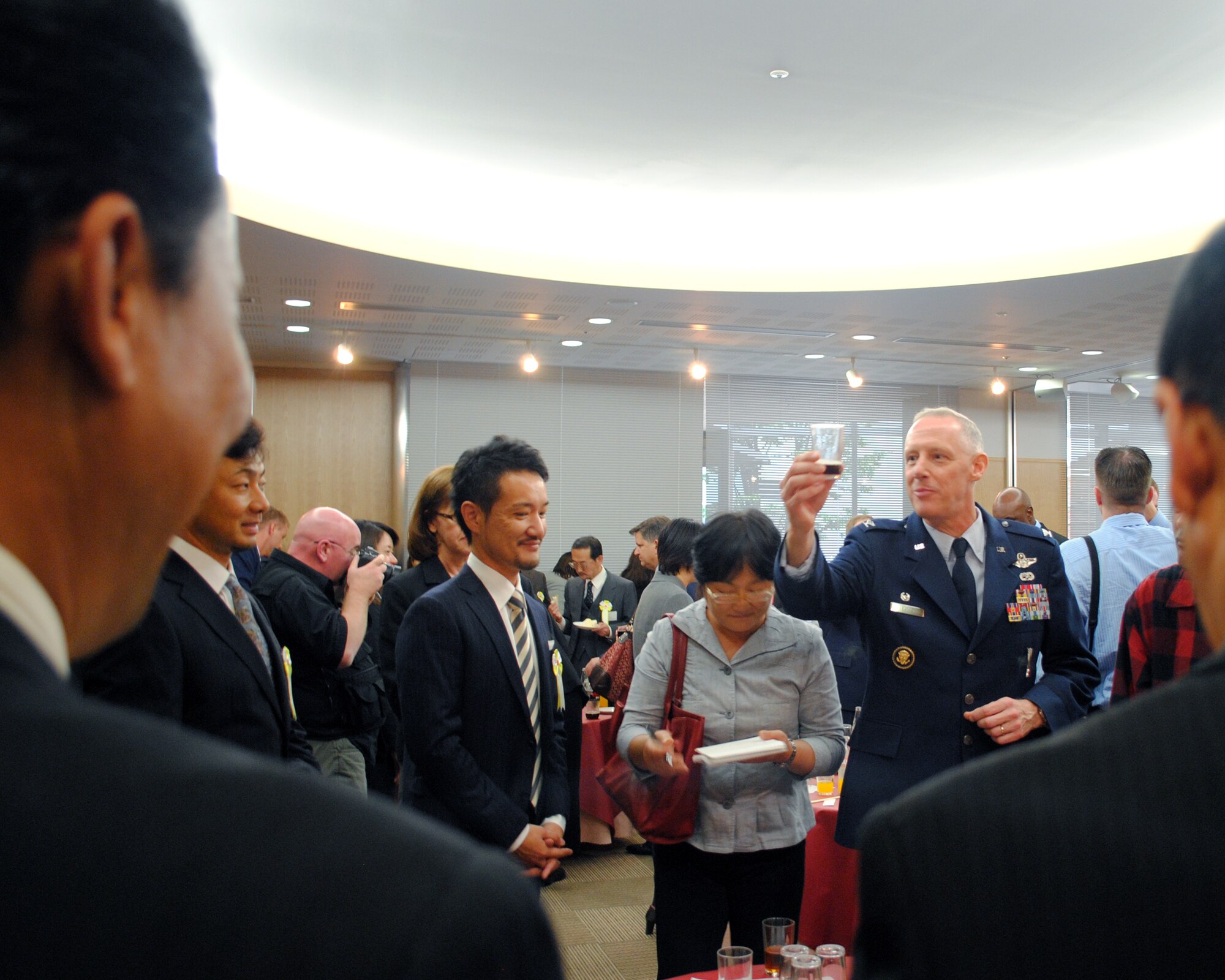 HAMURA, Japan -- Col. Otto Feather, 374th Airlift Wing commander, offers a toast to Japanese employees following the 2011 U.S. Forces, Japan Length of Service Awards Ceremony in Hamura City, Oct. 13, 2011. The ceremony honored 171 Japanese employees who have served with USFJ for 10, 20 and 30 years. (U.S. Air Force photo/Capt. Raymond Geoffroy)
