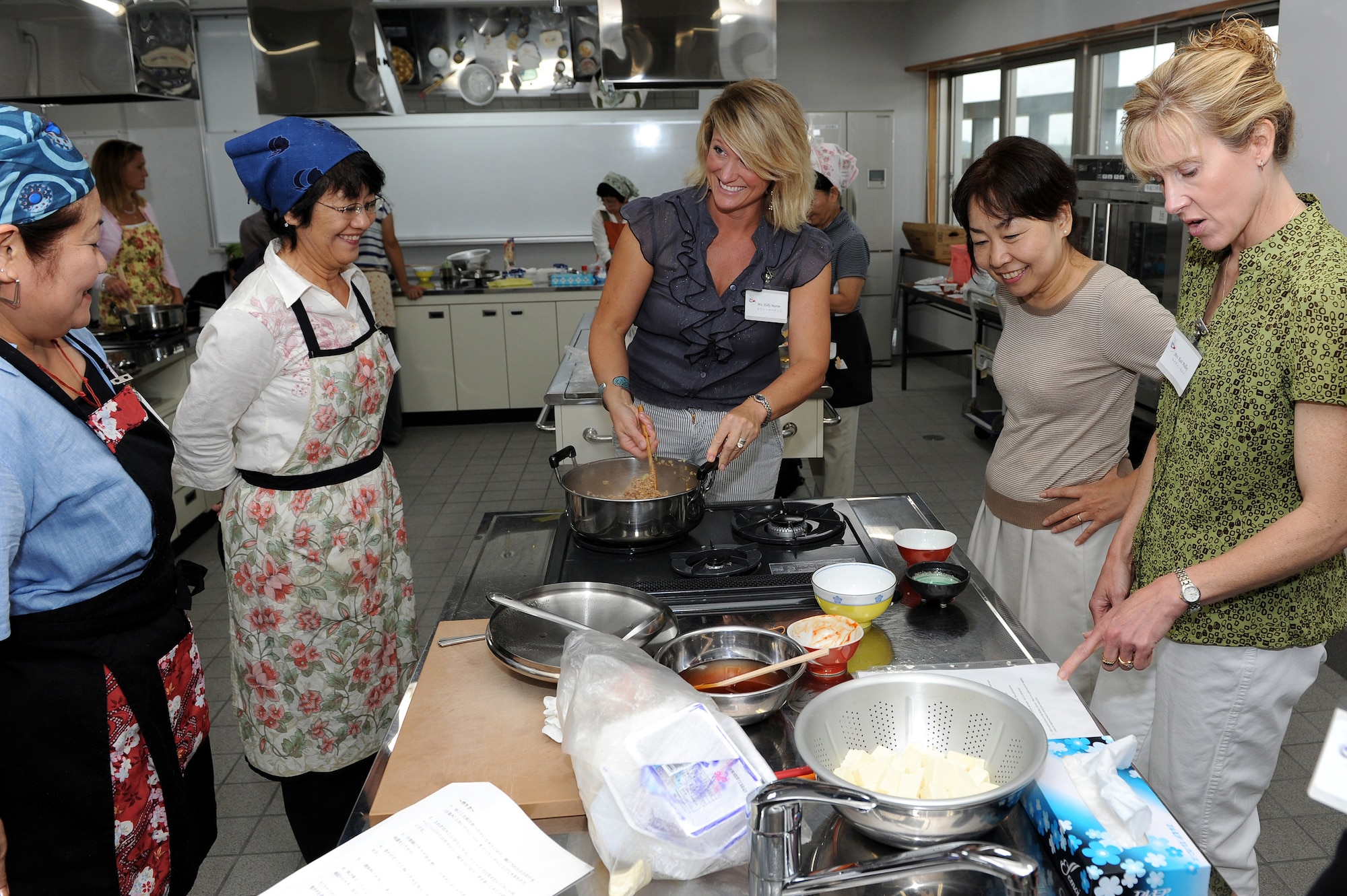 Members of Kadena Air Base participated in a cultural exchange cooking class with members of the local community at the Kadena Town Rotary Plaza Oct. 5. Those who attended the class learned to cook Yakisoba, Mabo Tofu and rice ball with salmon flakes during the cultural exchange. (U.S. Air Force photo/Junko Kinjo)