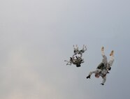 Army members from the Special Operations Command Korea's 39th Special Forces Detachment along with Air Force survival, evasion, resistance and escape specialists jump out of a C-130H Hercules from Yokota Air Base, Japan, at the Gunsan-Saemangeum Airshow in Gunsan City, Republic of Korea, Oct. 9, 2011. The U.S. Air Force and SOCKOR performed the jump together at 10,000 feet from a C-130, highlighting military free-fall operations. The City of Gunsan, the 8th Fighter Wing and the Republic of Korea Air Force’s 38th Fighter Group hosted the air show. (U.S. Air Force photo by Staff Sgt. Rasheen A. Douglas/Released)