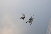 Army members from the Special Operations Command Korea's 39th Special Forces Detachment along with Air Force survival, evasion, resistance and escape specialists jump out of a C-130H Hercules from Yokota Air Base, Japan, at the Gunsan-Saemangeum Airshow in Gunsan City, Republic of Korea, Oct. 9, 2011. The U.S. Air Force and SOCKOR performed the jump together at 10,000 feet from a C-130, highlighting military free-fall operations. The City of Gunsan, the 8th Fighter Wing and the Republic of Korea Air Force’s 38th Fighter Group hosted the air show. (U.S. Air Force photo by Staff Sgt. Rasheen A. Douglas/Released)