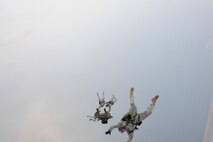 Army members from the Special Operations Command Korea's 39th Special Forces Detachment along with Air Force survival, evasion, resistance and escape specialists jump out of a C-130H Hercules from Yokota Air Base, Japan, at the Gunsan-Saemangeum Airshow in Gunsan City, Republic of Korea, Oct. 9, 2011. The U.S. Air Force and SOCKOR performed the jump together at 10,000 feet from a C-130, highlighting military free-fall operations. The City of Gunsan, the 8th Fighter Wing and the Republic of Korea Air Force’s 38th Fighter Group hosted the air show. (U.S. Air Force photo by Staff Sgt. Rasheen A. Douglas/Released)