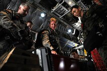 An Army member from the Special Operations Command Korea's 39th Special Forces Detachment positions his goggles before jumping out of the C-130H Hercules from Yokota Air Base, Japan, at the Gunsan-Saemangeum Airshow in Gunsan City, Republic of Korea, Oct. 9, 2011. The U.S. Air Force and SOCKOR performed a jump together at 10,000 feet from a C-130, highlighting military free-fall operations. The City of Gunsan, the 8th Fighter Wing and the Republic of Korea Air Force’s 38th Fighter Group hosted the air show. (U.S. Air Force photo by Staff Sgt. Rasheen A. Douglas/Released)