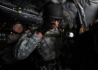 An Army member from the Special Operations Command Korea's 39th Special Forces Detachment positions his goggles before jumping out of the C-130H Hercules from Yokota Air Base, Japan, at the Gunsan-Saemangeum Airshow in Gunsan City, Republic of Korea, Oct. 9, 2011. The U.S. Air Force and SOCKOR performed a jump together at 10,000 feet from a C-130, highlighting military free-fall operations. The City of Gunsan, the 8th Fighter Wing and the Republic of Korea Air Force’s 38th Fighter Group hosted the air show. (U.S. Air Force photo by Staff Sgt. Rasheen A. Douglas/Released)