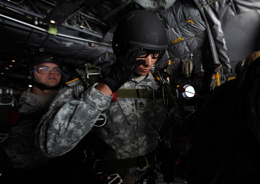 An Army member from the Special Operations Command Korea's 39th Special Forces Detachment positions his goggles before jumping out of the C-130H Hercules from Yokota Air Base, Japan, at the Gunsan-Saemangeum Airshow in Gunsan City, Republic of Korea, Oct. 9, 2011. The U.S. Air Force and SOCKOR performed a jump together at 10,000 feet from a C-130, highlighting military free-fall operations. The City of Gunsan, the 8th Fighter Wing and the Republic of Korea Air Force’s 38th Fighter Group hosted the air show. (U.S. Air Force photo by Staff Sgt. Rasheen A. Douglas/Released)