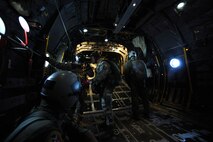 Tech. Sgt. Jason Martinez, an Air Force survival, evasion, resistance and escape specialist from the 8th Operations Support Squadron, and their NCO in charge of weapons, tactics and personnel recovery, briefs changes in wind speed to an Army member from the Special Operations Command Korea's 39th Special Forces Detachment in a C-130H Hercules from Yokota Air Base, Japan, during the Gunsan-Saemangeum Airshow in Gunsan City, Republic of Korea, Oct. 8, 2011. The U.S. Air Force and SOCKOR were performing a jump together at 10,000 feet from a C-130, highlighting military free-fall operations during the Gunsan Saemangeum Airshow in Gunsan City. (U.S. Air Force photo by Staff Sgt. Rasheen A. Douglas/Released)