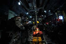 Tech. Sgt. Jason Martinez, an Air Force survival, evasion, resistance and escape specialist from the 8th Operations Support Squadron, and their NCO in charge of weapons, tactics and personnel recovery, goes over coordinates to land with an Army member from the Special Operations Command Korea's 39th Special Forces Detachment in a C-130H Hercules from Yokota Air Base, Japan, at the Gunsan-Saemangeum Airshow in Gunsan City, Republic of Korea, Oct. 8, 2011. The U.S. Air Force and SOCKOR performed the jump together at 10,000 feet from a C-130 highlighting military free-fall operations. The City of Gunsan, the 8th Fighter Wing and the Republic of Korea Air Force’s 38th Fighter Group hosted the air show. (U.S. Air Force photo by Staff Sgt. Rasheen A. Douglas/Released)