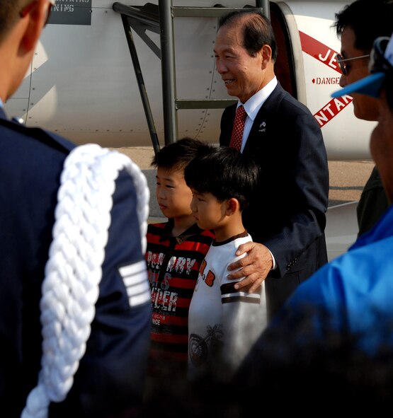 Two young Korean boys pose for a photo with the Gunsan City mayor during the 2011 Gunsan-Saemangeum Air Show at Kunsan Air Base, Republic of Korea, Oct. 8, 2011. The air show featured many static displays and performances from across the Pacific Air Forces and Korean peninsula. (U.S. Air Force photo by Senior Airman Benjamin Stratton/Released)