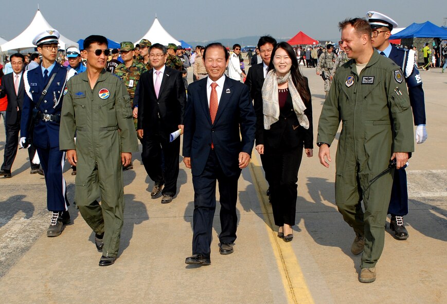 Col. Stephen Williams, 8th Fighter Wing vice commander, shows the Gunsan City mayor around the static display and open house portion of the 2011 Gunsan-Saemangeum Air Show at Kunsan Air Base, Republic of Korea, Oct. 8, 2011. The air show featured many static displays and performances from across the Pacific Air Forces and Korean peninsula. (U.S. Air Force photo by Senior Airman Benjamin Stratton/Released)