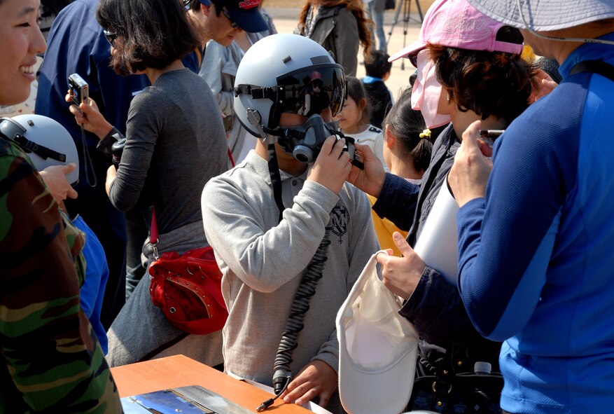 A Korean boy tries out a Republic of Korea Air Force ‘Black Eagles’ flight helmet during the 2011 Gunsan-Saemangeum Air Show at Kunsan Air Base, Republic of Korea, Oct. 8, 2011. The air show featured many static displays and performances from across the Pacific Air Forces and Korean peninsula. (U.S. Air Force photo by Senior Airman Benjamin Stratton/Released)
