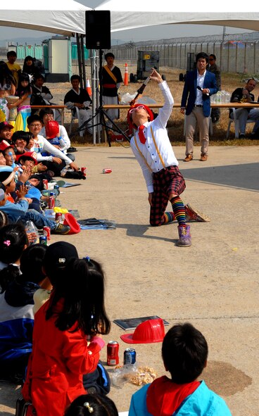 A clown from the local community performs for the intermixed Korean-American audience during the 2011 Gunsan-Saemangeum Air Show at Kunsan Air Base, Republic of Korea, Oct. 8, 2011. The air show featured many static displays and performances from across the Pacific Air Forces and Korean peninsula. (U.S. Air Force photo by Senior Airman Benjamin Stratton/Released)