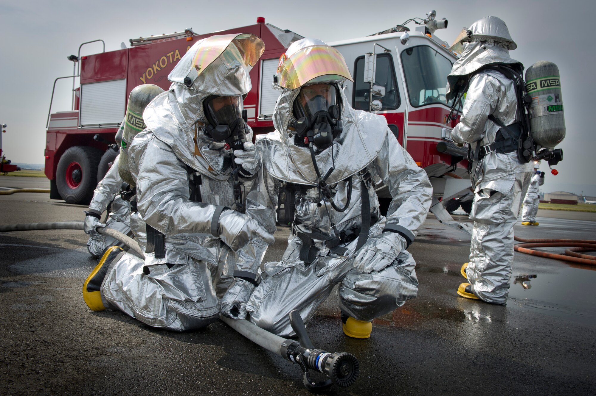 YOKOTA AIR BASE, Japan -- Col. Otto Feather, 374th Airlift Wing commander receives instructions from a  firefighter from the 374th Civil Engineer Squadron on how to extinguish a fire on an simulated aircraft, Oct. 11, 2011, during a live-fire training exercise at Yokota Air Base, Japan. The firefighters participate in this type of training to keep their skills sharp and always stay ready for fire emergencies. (U.S. Air Force photo/ Staff Sgt. Stacy Moless)
