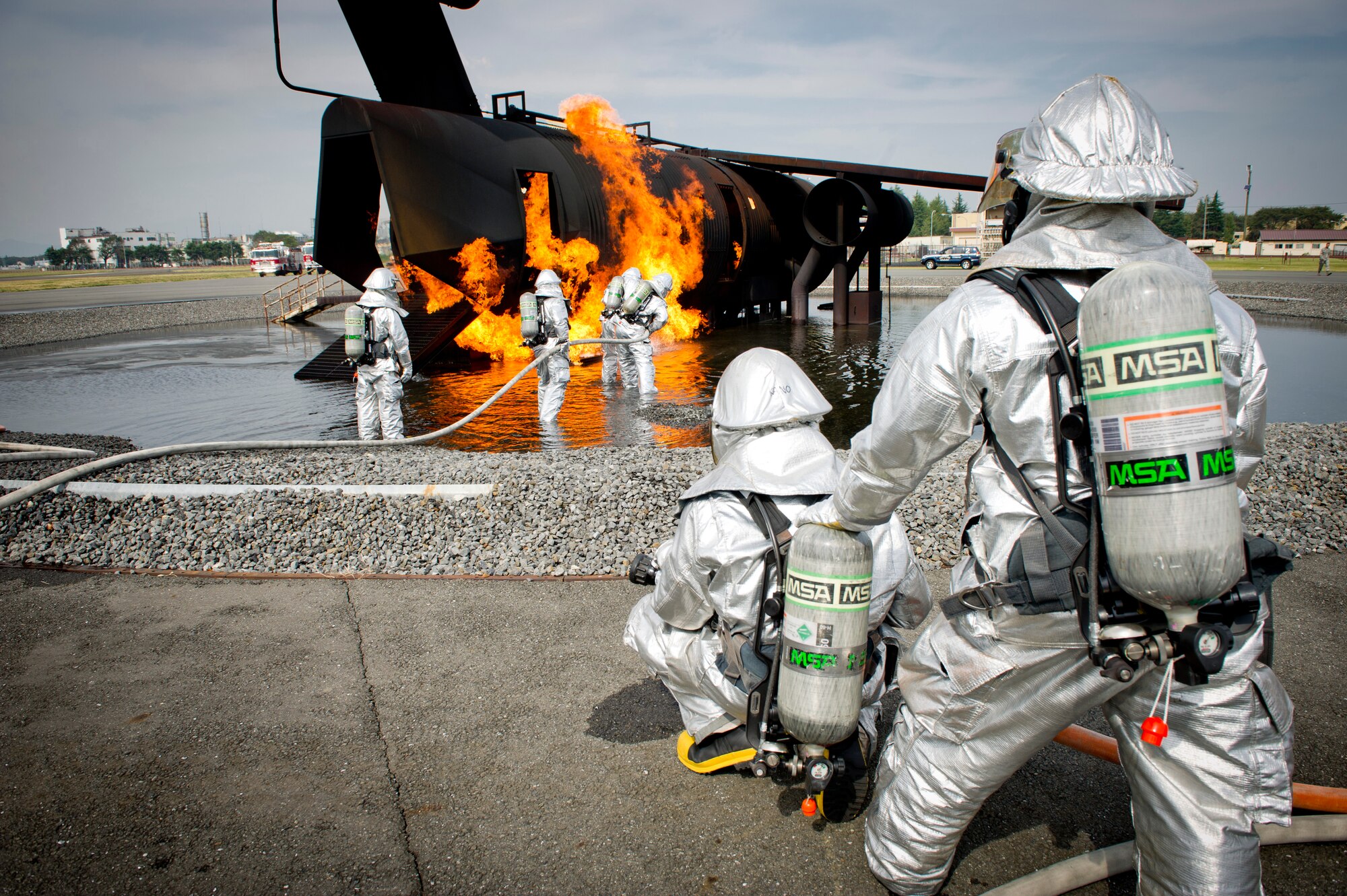 YOKOTA AIR BASE, Japan -- Firefighters from the 374th Civil Engineer Squadron extinguish a fire on an simulated aircraft, Oct. 11, 2011, during a live-fire training exercise at Yokota Air Base, Japan. The firefighters participate in this type of training to keep their skills sharp and always stay ready for fire emergencies. (U.S. Air Force photo/ Staff Sgt. Stacy Moless)