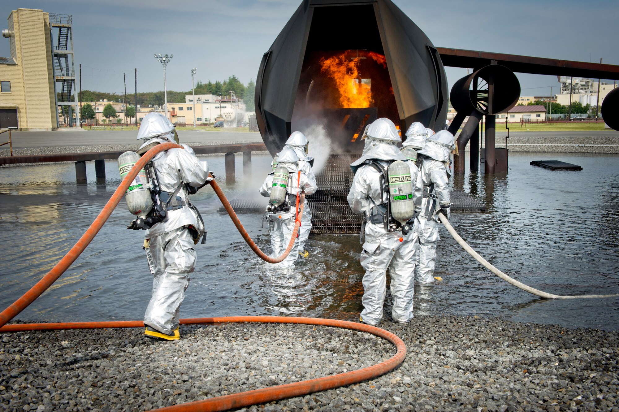 YOKOTA AIR BASE, Japan -- Firefighters from the 374th Civil Engineer Squadron extinguish a fire on an simulated aircraft, Oct. 11, 2011, during a live-fire training exercise at Yokota Air Base, Japan. The firefighters participate in this type of training to keep their skills sharp and always stay ready for fire emergencies. (U.S. Air Force photo/ Staff Sgt. Stacy Moless)