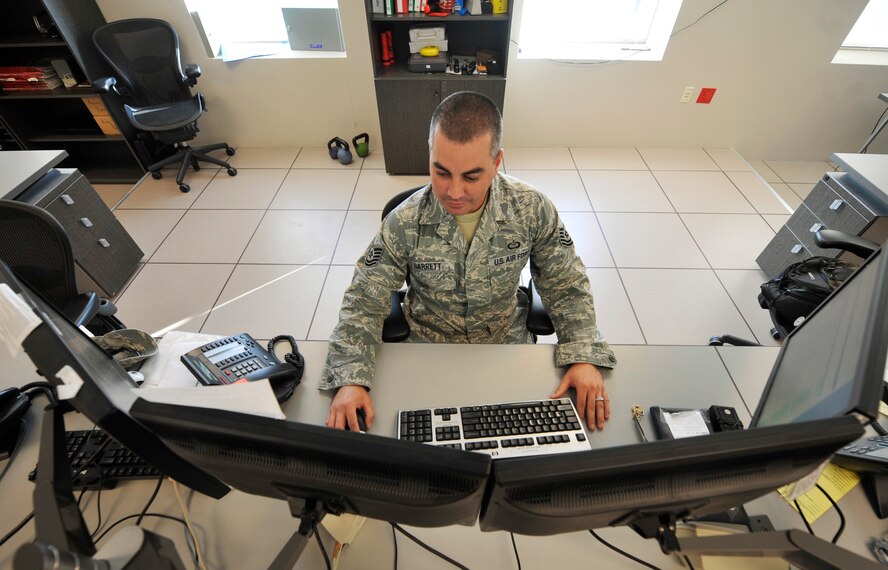 Tech. Sgt. Michael Garrett, 26th Operational Weather Squadron weather forecaster, analyzes charts on the ops floor on Barksdale Air Force Base, La., Oct. 13. The 26 OWS is responsible for forecasting weather and issuing warnings for the entire southeast United States. (U.S. Air Force photo/Senior Airman Chad Warren)(RELEASED)