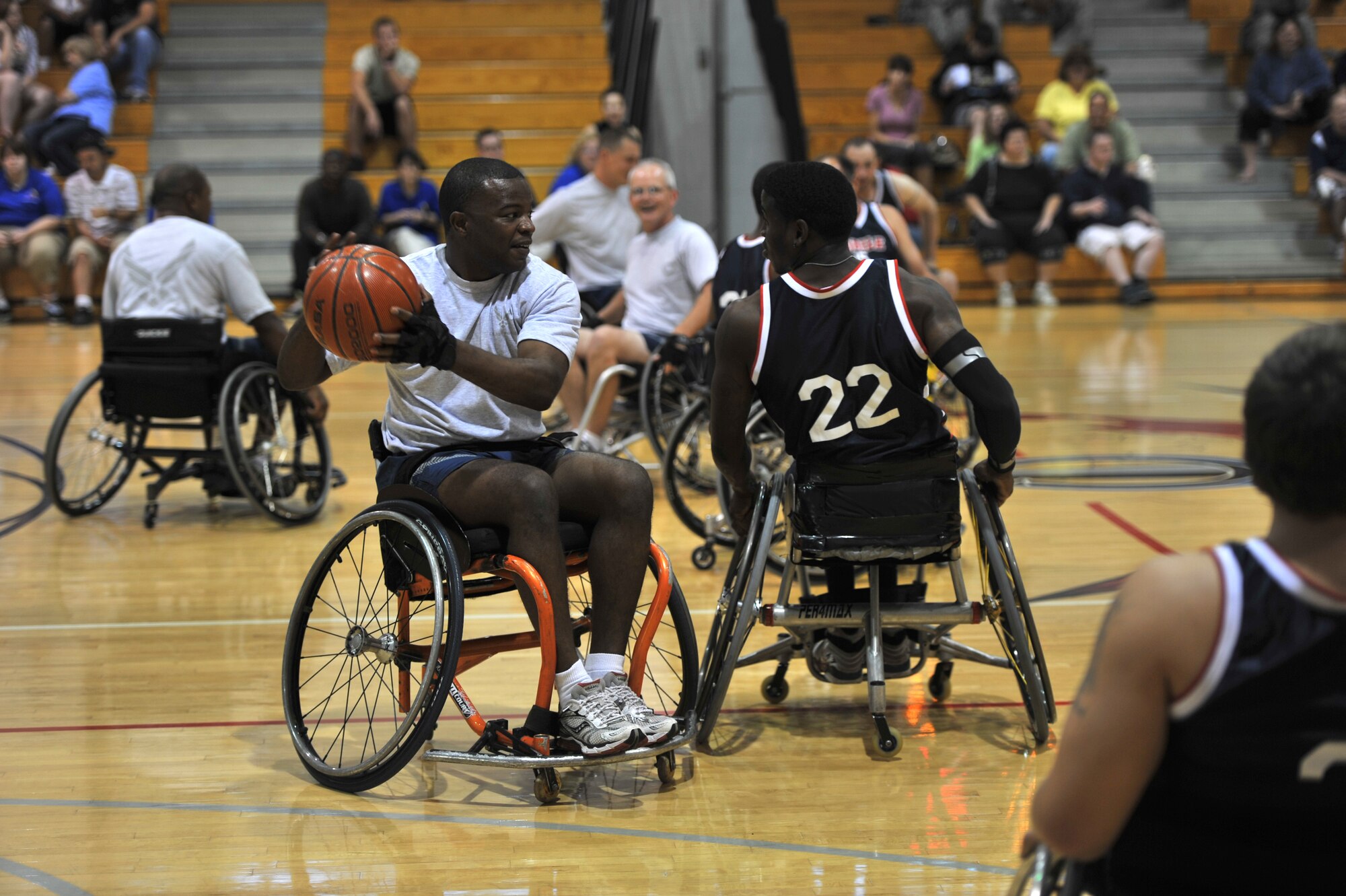 U.S. Air Force Capt. Myron Chivis, executive officer of the 1st Special Operations Wing, left, and D. Q. Robinson, a wheelchair basketball player from the Mobile Patriots, right, compete during the sixth annual Wheel Chair Basketball Exhibition Game at Aderholt Fitness Center on Hurlburt Field, Fla., Oct. 7, 2011. The Patriots have been ranked fourth place in the country and have finished in the top 25 teams in the America over the last 10 years. (U.S. Air Force photo/Airman 1st Class Hayden K Hyatt)(RELEASED)