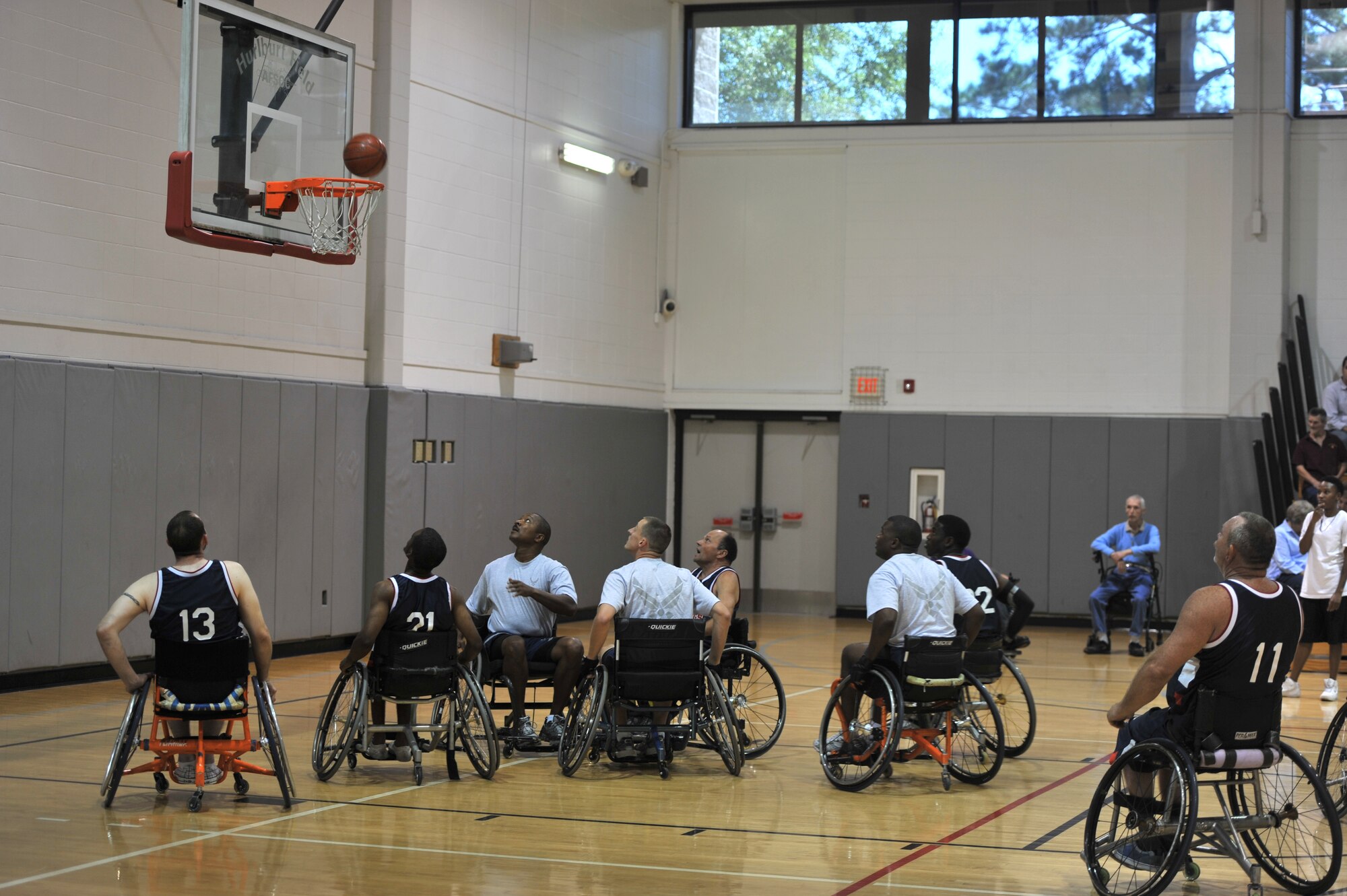 Air Commandos and players from the Mobile Patriots keep their eyes on the ball during the sixth annual Wheelchair Basketball Exhibition Game at the Aderholt Fitness Center on Hurlburt Field, Fla., Oct. 7, 2011. The game ended with a tie of 52-52. (U.S. Air Force photo/Airman 1st Class Hayden K Hyatt)(RELEASED)