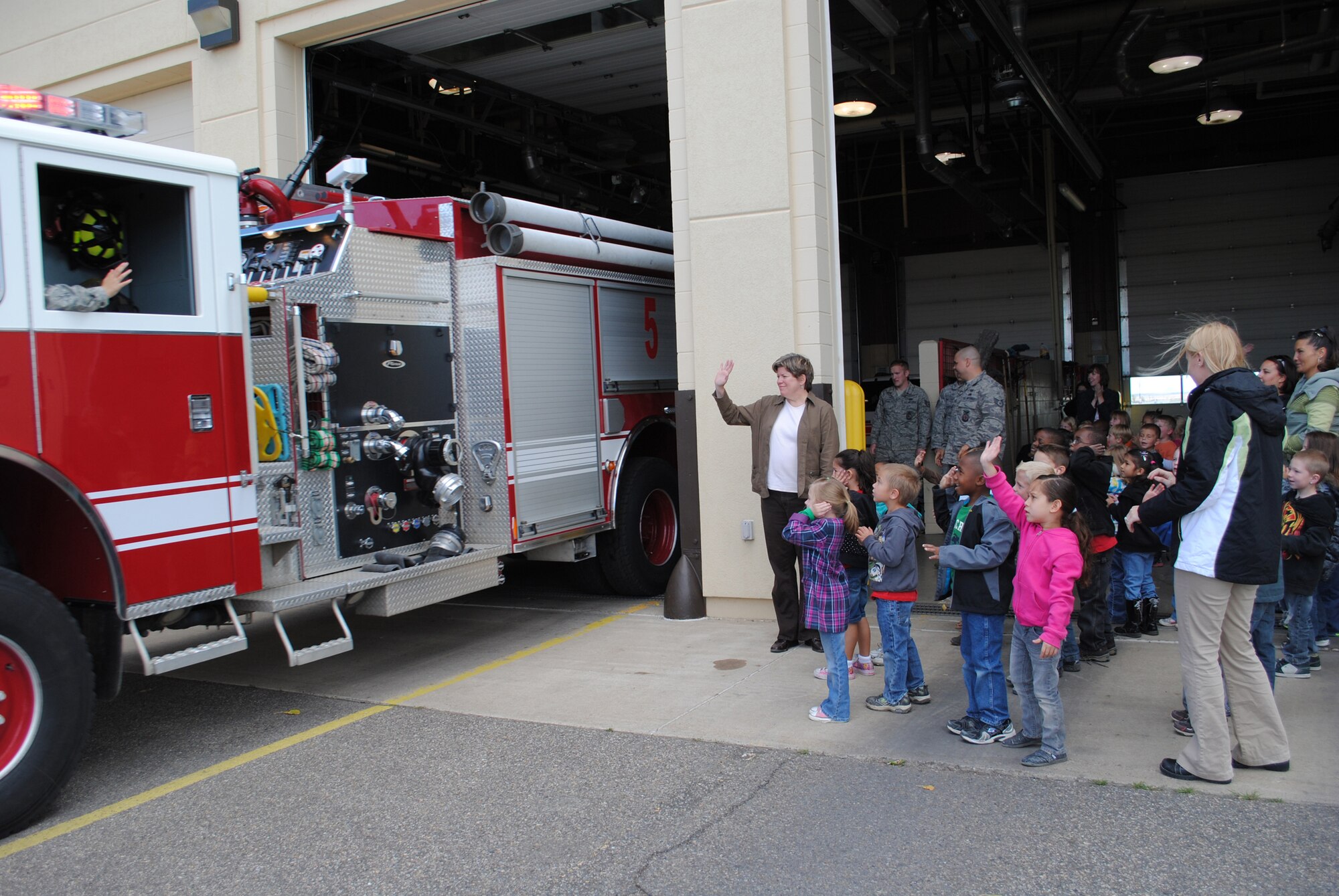 The teachers and students wave goodbye to a firefighting crew as they depart the Malmstrom Fire Station Oct. 11.  (U.S. Air Force photo/Airman Cortney Paxton)