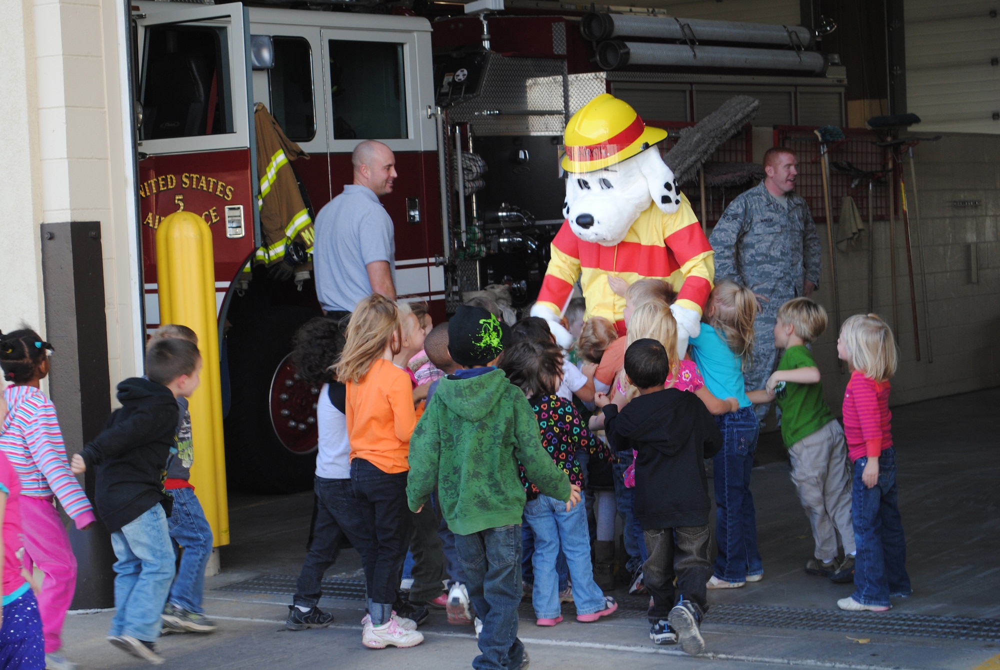 Kindergarten students from Loy Elementary School eagerly greet Sparky the Fire Dog at the beginning of their tour of the Malmstrom Fire Department Oct. 11.  (U.S. Air Force photo/Airman Cortney Paxton)