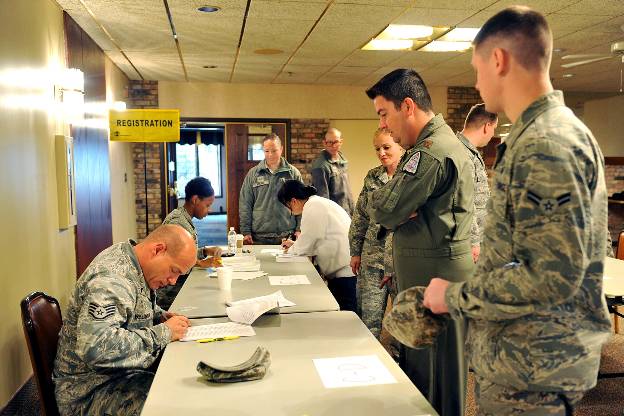 U.S. Air Force Staff Sgt. Mark Williamson, 55th Medical Support Squadron, checks in Team Offutt members during a point of dispensing exercise in the Community Activity Center on Offutt Air Force Base, Neb., Oct. 7. The exercise is an annual requirement which tests the 55 Wing's Disease Containment Plan and response to a biological terrorist attack. (U.S. Air Force photo by Charles Haymond/Released)
