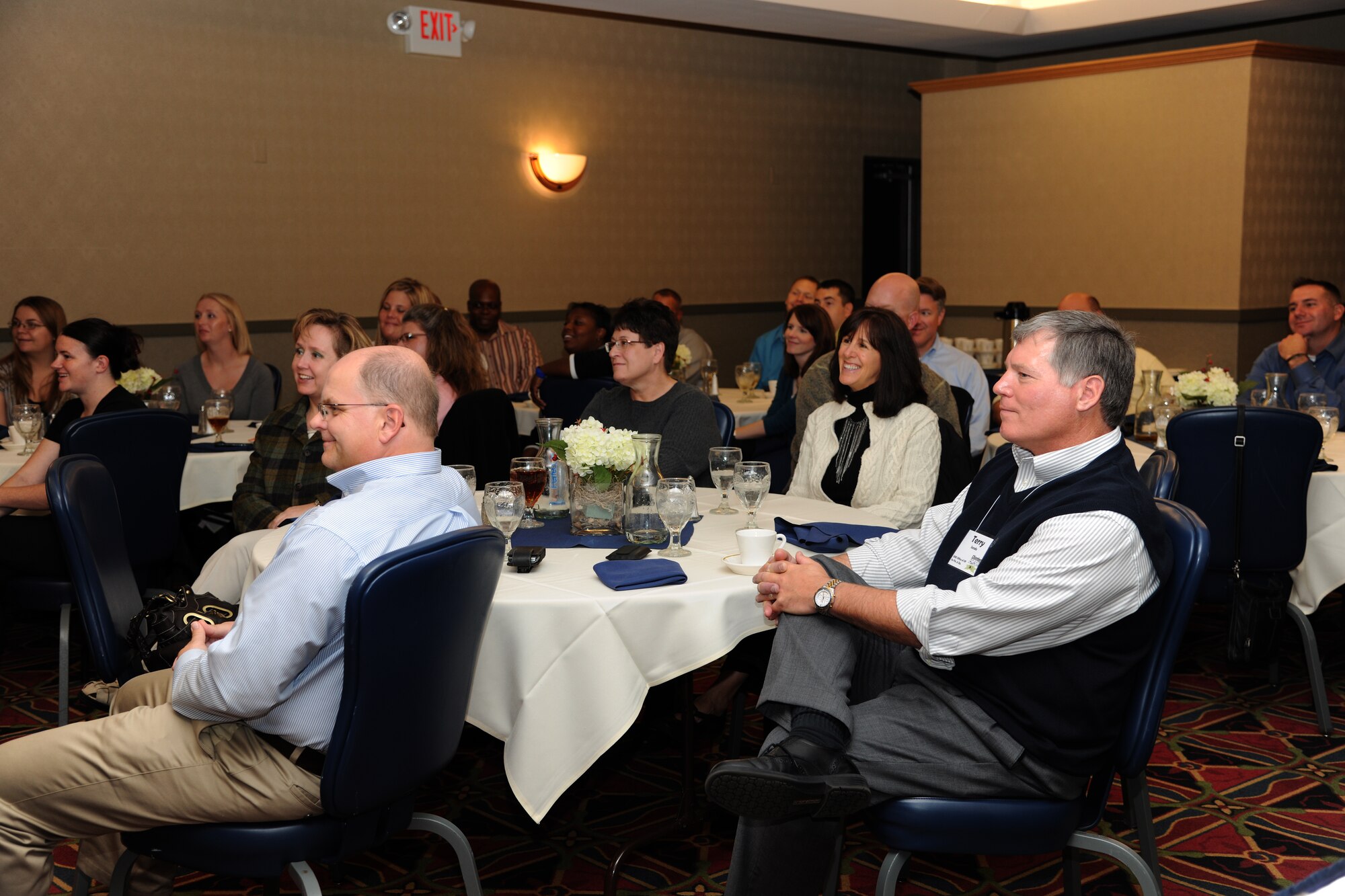 Members of the Grand Forks Chamber of Commerce listen to speakers at J.R. Rockers Café during a day-long base tour on Oct. 12 on Grand Forks Air Force Base, N.D. The chamber holds the annual training to help develop local leaders and officials say the visit to the base is important to helping civilians in the course understand the importance of the military in the community. (U.S. Air Force photo by Airman 1st Class Ashley N. Taylor) 