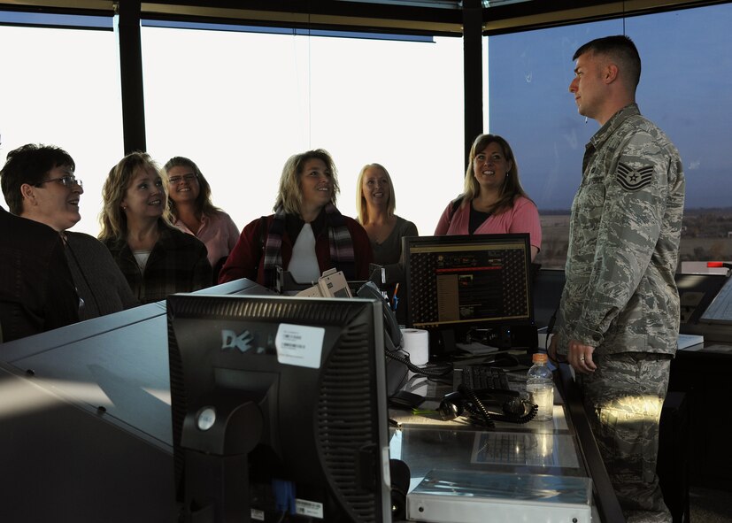 U.S. Air Force Tech. Sgt. Sean Strong of the 319th Operations Support Squadron talks to members of the Grand Forks/East Grand Forks Chamber of Commerce during a presentation at the radar approach control tower during a day-long base tour on Oct. 12 on Grand Forks Air Force Base, N.D. The chamber holds the annual training to help develop local leaders and officials say the visit to the base is important to helping civilians in the course understand the importance of the military in the community. (U.S. Air Force photo by Airman 1st Class Ashley N. Taylor)