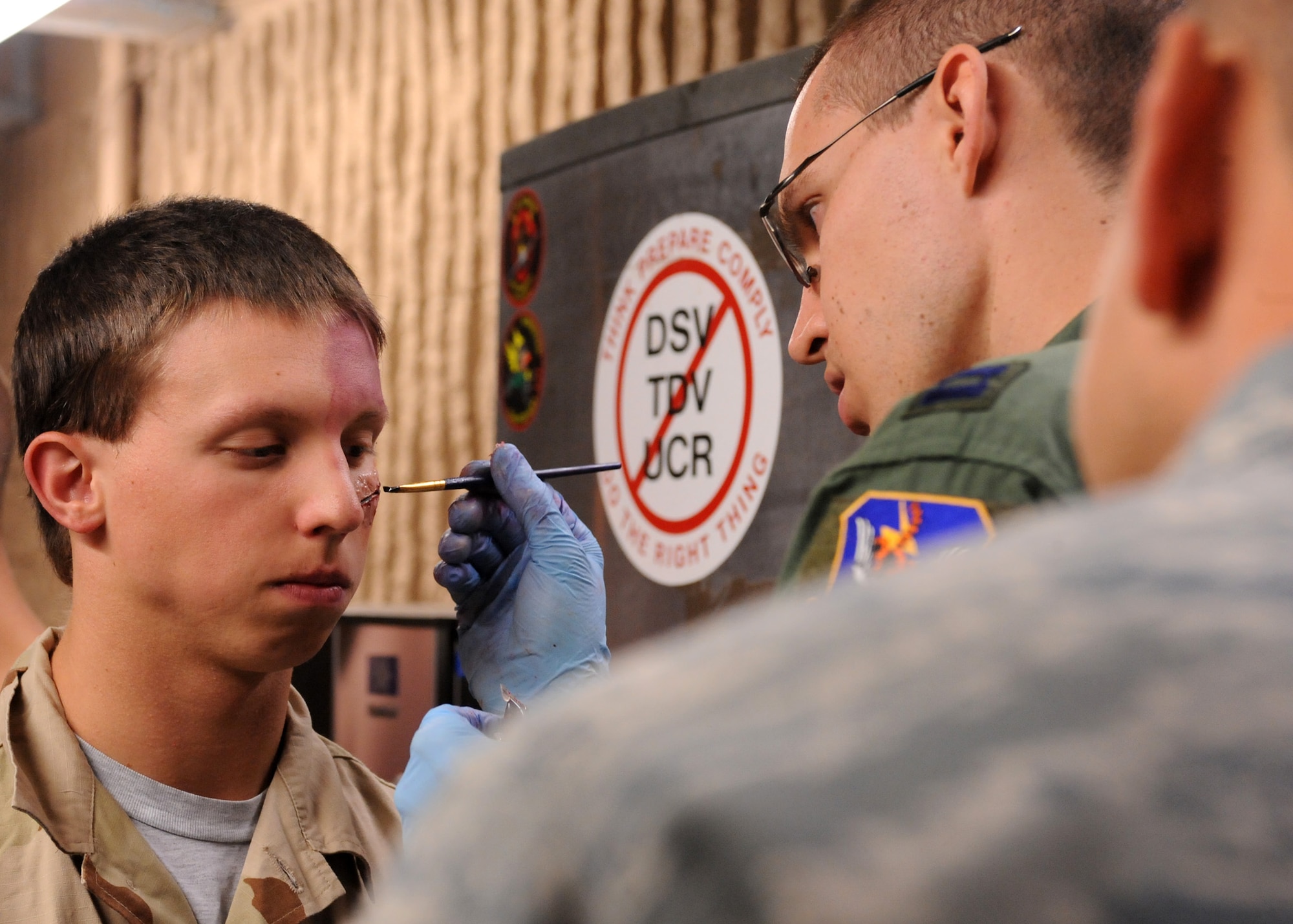 DAVIS-MONTHAN AIR FORCE BASE, Ariz. – Capt. Erik DeSoucy, 563rd Operations Support Squadron flight physician, paints fake blood on the simulated wound of a volunteer at his moulage station during the Angel Thunder exercise here Oct. 11. Approximately 1,400 U.S. Military, federal and state employees, and coalition forces are participating in the fifth-annual Angel Thunder exercise, the largest military combat search and rescue exercise in the world. (U.S. Air Force photo/Airman 1st Class Timothy D. Moore)