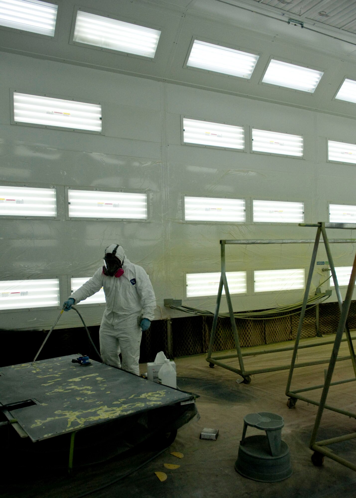 Staff Sgt. Felix Irving, 28th Maintenance Squadron aircraft structural maintenance craftsman, preps and sands a B-1B Lancer door in the corrosion control facility paint booth on Ellsworth Air Force Base, S.D., Oct. 12, 2011. Irving was prepping the door for paint, to ensure the aircraft is ready to fly safely in support of any national objectives. (U.S. Air Force photo by Airman 1st Class Kate Thornton/Released)
