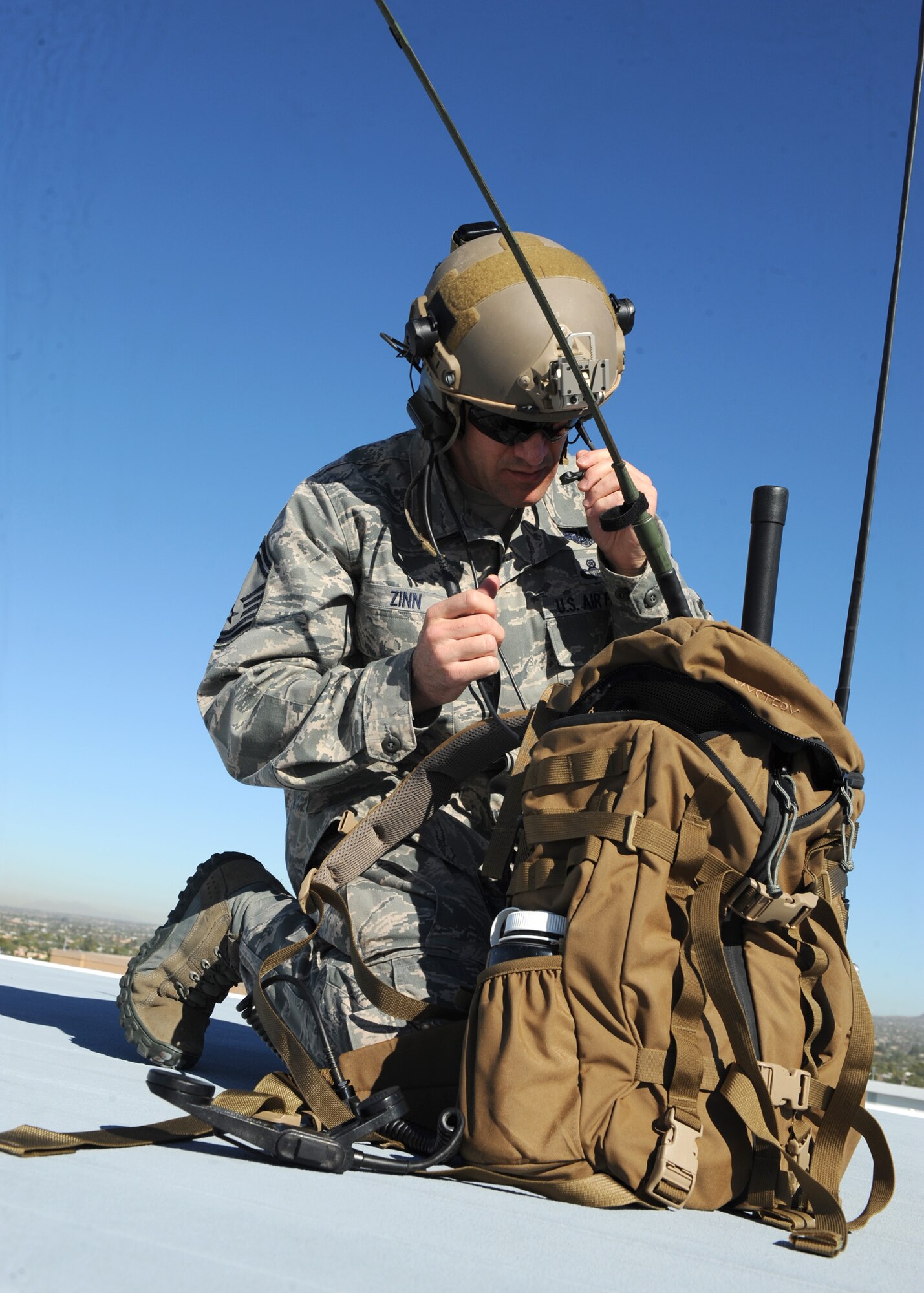 U.S. Air Force Senior Master Sgt. Nathan Zinn, 48th Rescue Squadron superintendent, checks his radio equipment in preparation of Angel Thunder at University of Arizona Medical Center Oct. 11.  Angel Thunder has been specifically designed to incorporate “whole-of-government,” ensuring that every government department and agency understands the core competencies, roles, missions and capabilities of its partners and works together to achieve common goals. (U.S. Air Force photo by Senior Airman Brittany Dowdle)