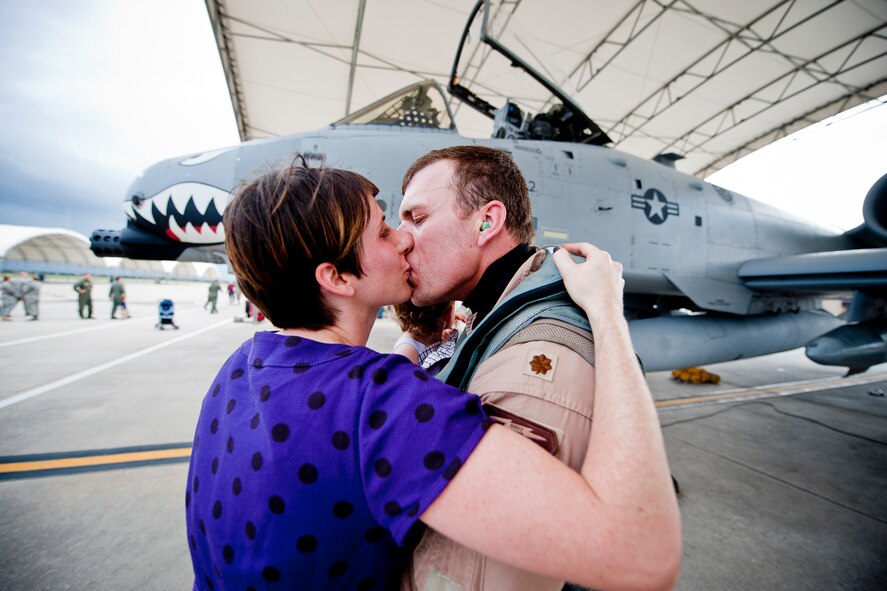 U.S. Air Force Maj. Craig Morash, 74th Fighter Squadron A-10 pilot, shares a kiss with his wife, Jennifer, after returning home from a deployment Oct. 11, 2011, at Moody Air Force Base, Ga. Morash was part of a six-month deployment to Kandahar Air Field, Afghanistan, where he supported Operation Enduring Freedom. (U.S. Air Force photo by Staff Sgt. Jamal D. Sutter/Released) 