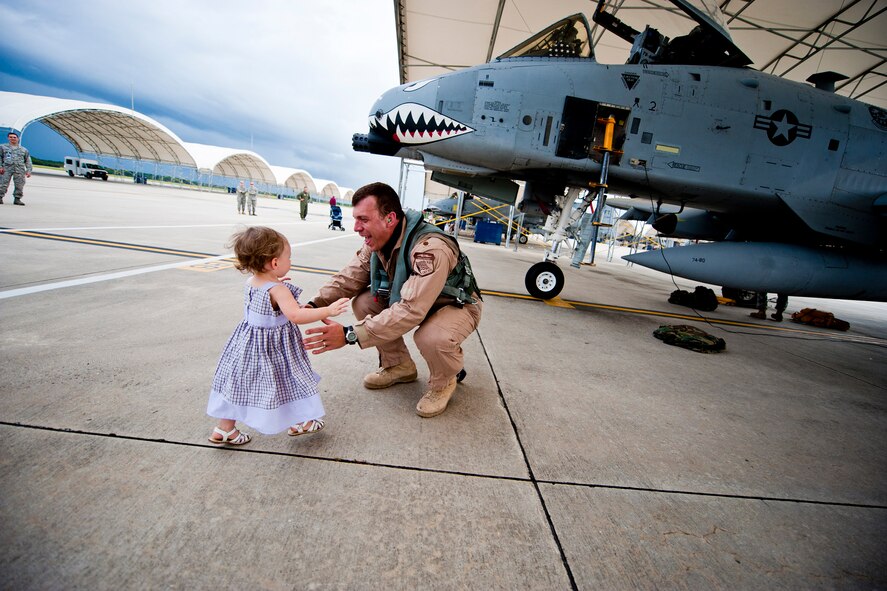 U.S. Air Force Maj. Craig Morash, 74th Fighter Squadron A-10 pilot, is greeted home by his daughter, Adeline, after returning from a deployment Oct. 11, 2011, at Moody Air Force Base, Ga. Morash was part of a six-month deployment to Kandahar Air Field, Afghanistan, where he supported Operation Enduring Freedom. (U.S. Air Force photo by Staff Sgt. Jamal D. Sutter/Released) 
