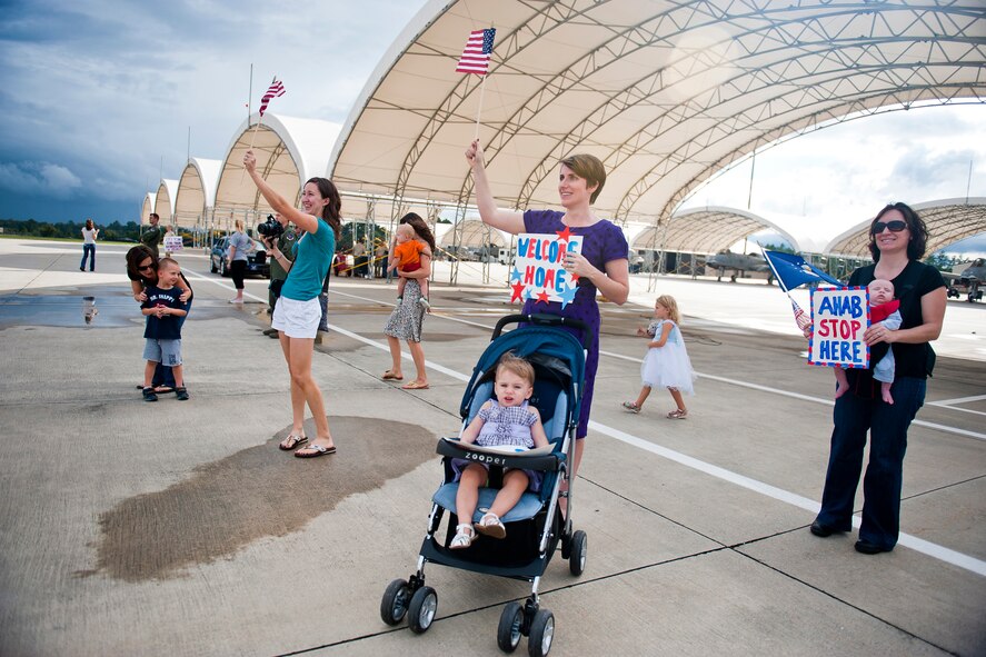 Family and friends of 74th Fighter Squadron Airmen greet A-10C Thunderbolt II pilots as they return from deployment Oct. 11, 2011, at Moody Air Force Base, Ga. The pilots flew the A-10s during a six-month deployment to Kandahar Air Field, Afghanistan, where they supported U.S. and coalition ground forces. (U.S. Air Force photo by Staff Sgt. Jamal D. Sutter/Released)