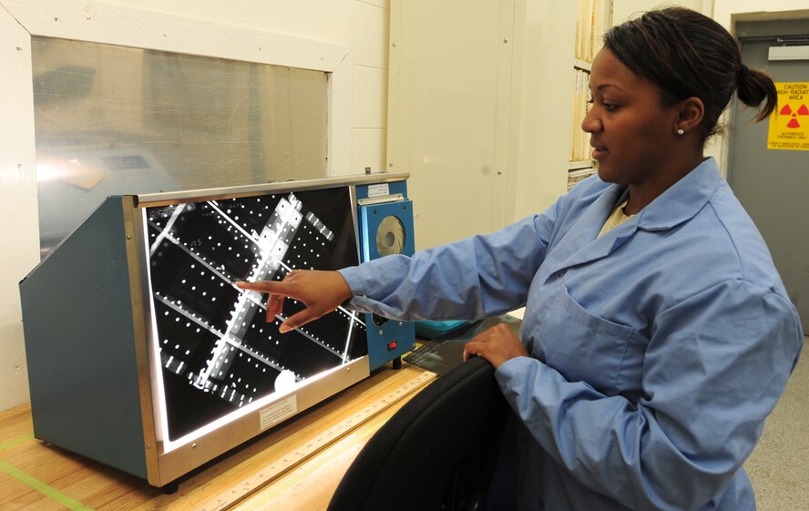 U.S. Air Force Staff Sgt. Tanita Johnson, 23rd Equipment Maintenance Squadron non-destruction inspections (NDI) floor lead, reviews parts of an aircraft through an X-ray at Moody Air Force Base, Ga., Oct. 11, 2011. The NDI lab uses different specialized equipment to find defects in aircraft.  (U.S. Air Force photo by Staff Sgt. Stephanie Mancha/Released)
