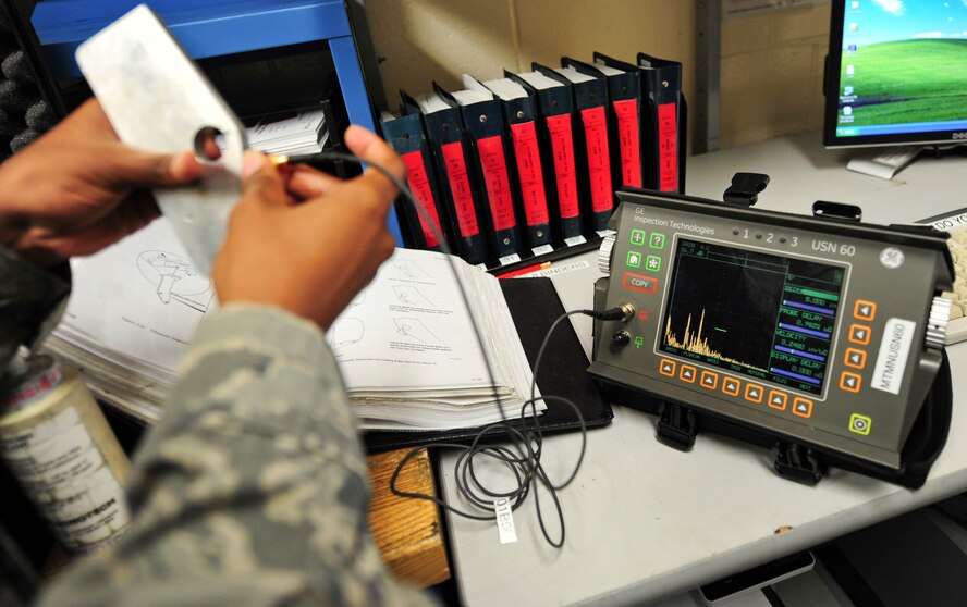 U.S. Air Force Staff Sgt. Tanita Johnson, 23rd Equipment Maintenance Squadron non-destruction inspections (NDI) floor lead, demonstrates how to use an ultrasonic scanner to detect defects in aircraft parts at Moody Air Force Base, Ga., Oct. 11, 2011. The NDI unit supports the A-10C Thunderbolt II, HC-130P Combat King and HH-60G Pave Hawk.  (U.S. Air Force photo by Staff Sgt. Stephanie Mancha/Released)