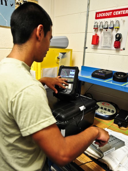 U.S. Air Force Airman 1st Class Dominic Urrutia, 23rd Equipment Maintenance Squadron non-destruction inspections apprentice, calibrates an eddy current flaw detector before going out to an aircraft at Moody Air Force Base, Ga., Oct. 11, 2011. Flaw detectors help find defects in aircraft materials and surfaces the human eye can’t see. (U.S. Air Force photo by Staff Sgt. Stephanie Mancha/Released)