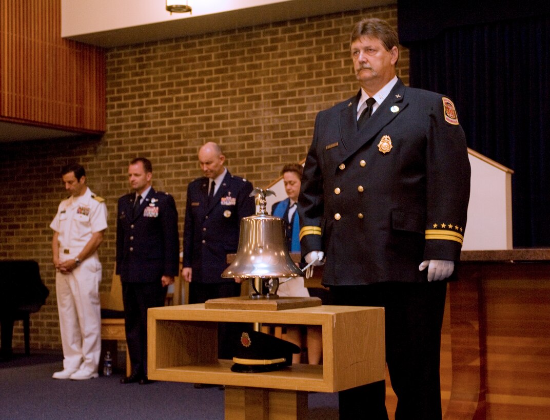 John McDonald, Joint Base Anacostia-Bolling and Naval District if Washington battalion fire chief, rings a ceremonial bell in remembrance of 9/11 victims inside the JABAB Chapel Center sanctuary Sept. 11. (Photo by Bobby Jones)